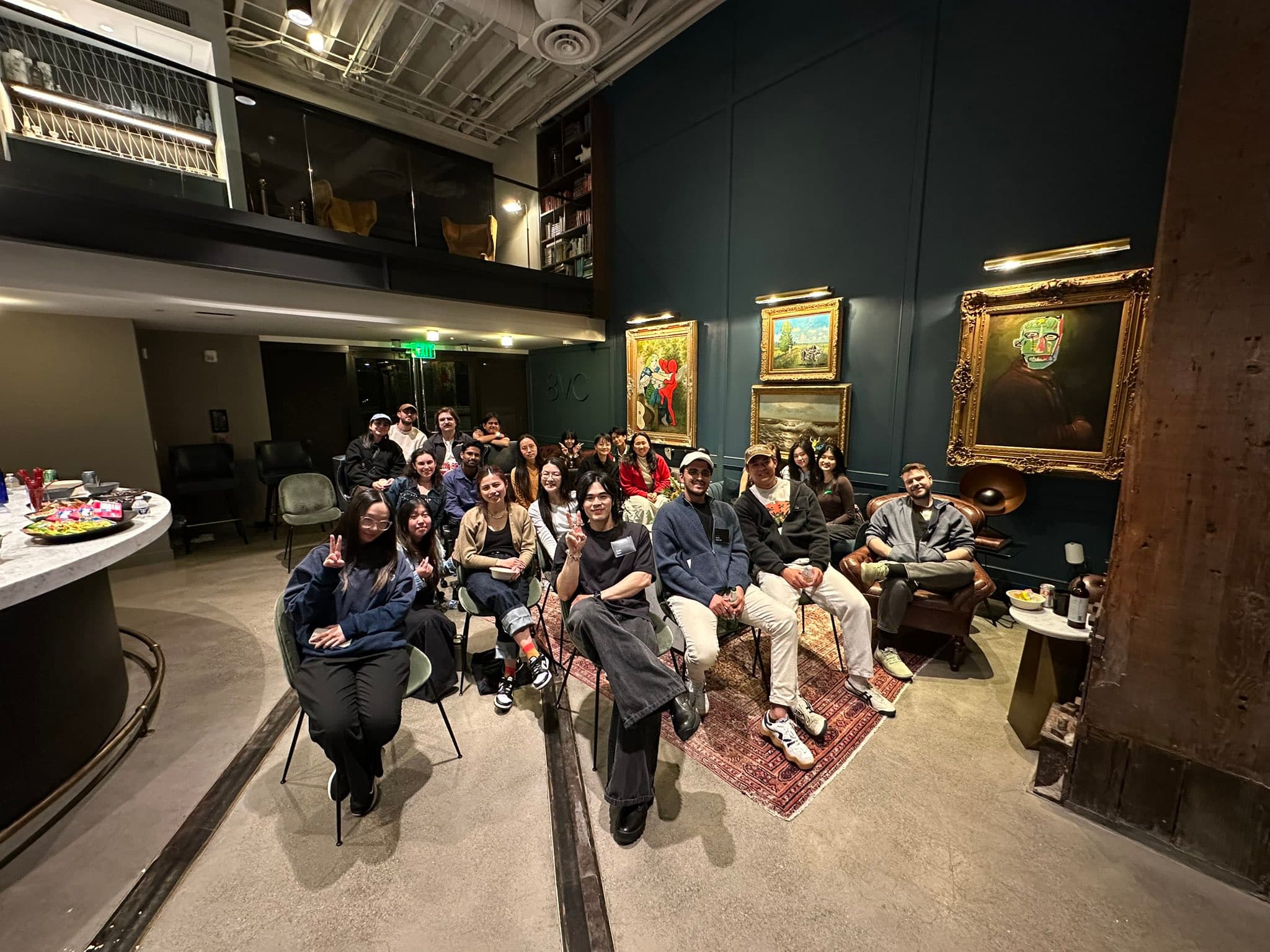 Gathering in a gallery lounge with art on the walls