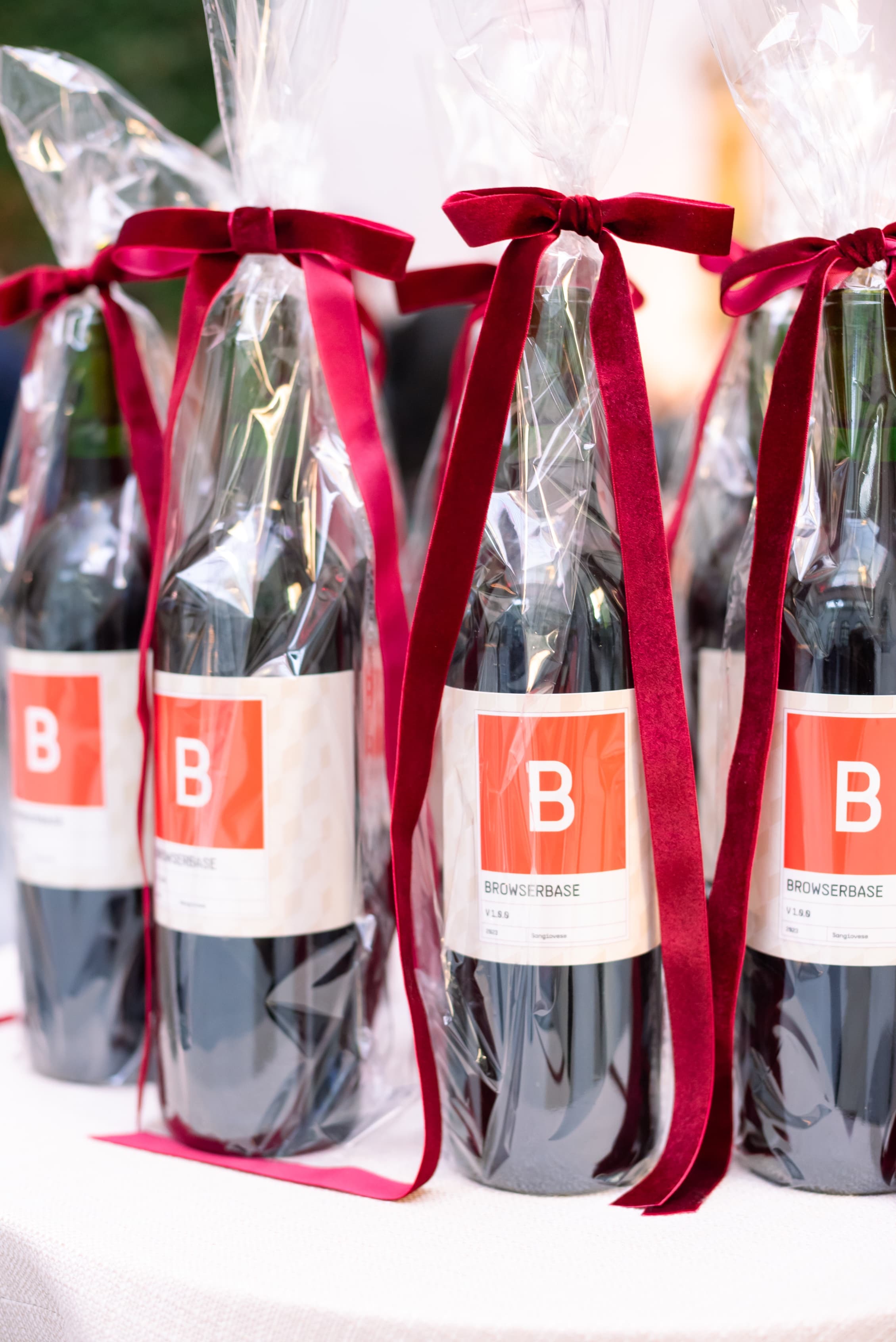 Custom Browserbase-labeled wine bottles wrapped with red ribbon